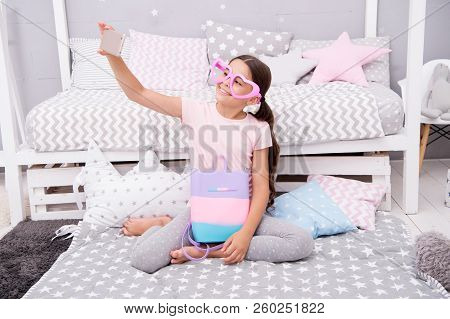 Subscribe Her Vlog. Vlogger Streaming Video. Girl Child Sit On Bed In Her Bedroom And Taking Selfie 