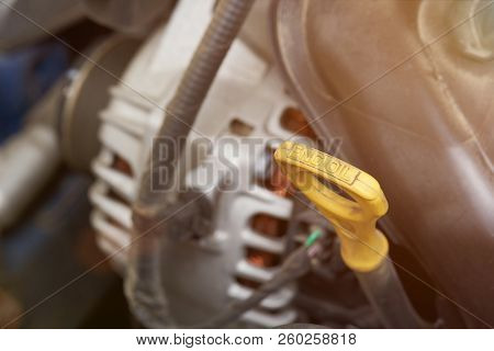 Yellow Plastick Oil Dipstick Close Up On Engine Background