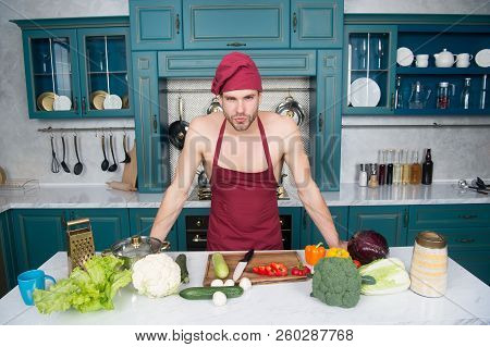 Attractive Chef Ready To Cook. Muscular Chef Posing In Kitchen. Cook Delicious Recipe. Sexy Macho Co