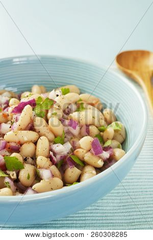 Italian Cannelini Bean Salad Of Beans In Lemon Vinaigrette With Red Onion, Rosemary, Parsley And Gar