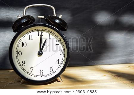 1 Am/pm Back To School Concept. Alarm Clock On Wooden With Blackboard On Background