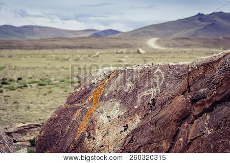 Tarkhatinsky Megalithic Complex Fragment. Ancient Petroglyphs. Altai Russia Toning Sunrise