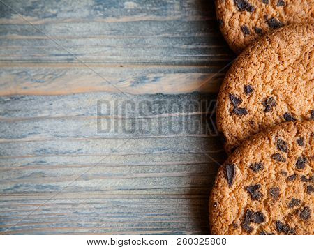 Food Sweet Stuff Decor On Rough Wooden Background. Chocolate Chip Cookies On Timber Surface With Fre