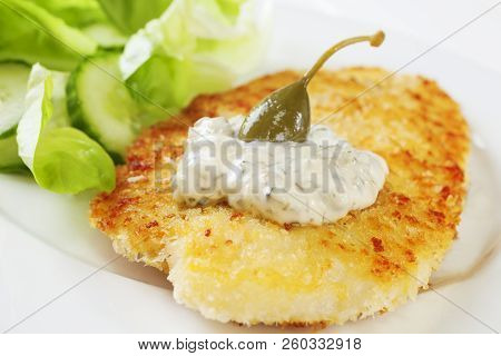 Breaded Fish With Tartare Sauce And A Caperberry, Served With Salad. Homemade Food.