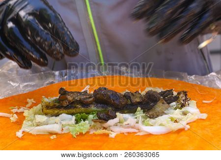 Fast Food Vegan Roll Wrap Cooking Process With Gloved Hands And Vegetables Ingradients Close Up Phot