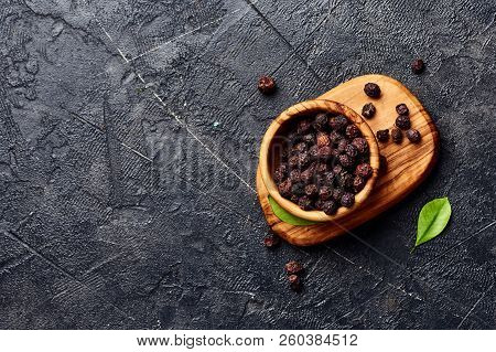 Dried Hawthorn Fruits On Black Background. Top View Of Crataegi Fructus.