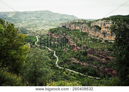 Road Between Mountains, Located In A Wooded Area.