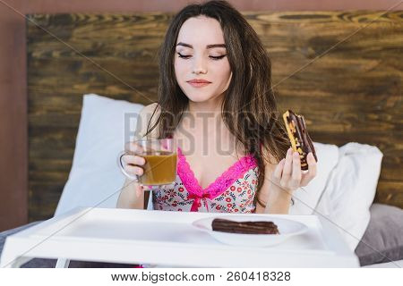 Girl With Cake In Bed Drinking Coffee