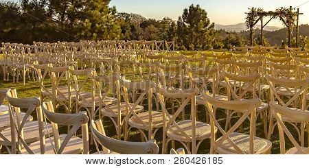 Rows And Columns Of Chairs Facing A Chuppah