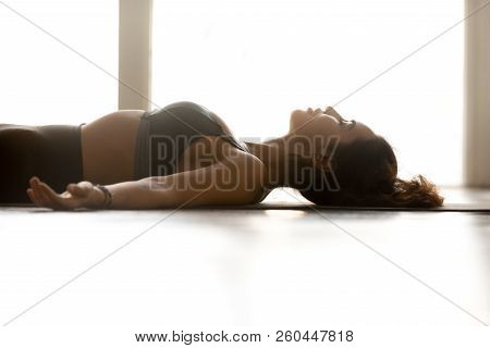 Young Attractive Woman Practicing Yoga, Corpse Pose, Close Up