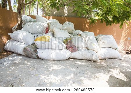 Big Bags Of Waste Plastic Bottles And Other Types Of Plastic Waste At The Waste Disposal Site. Waste