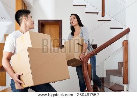Cheerful Young Asian Married Couple Moving Out