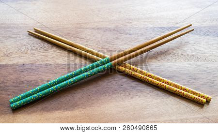 Natural Bamboo Chopsticks On Wooden Table Background.