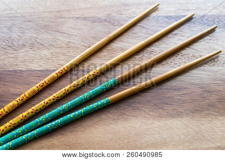 Natural Bamboo Chopsticks On Wooden Table Background.