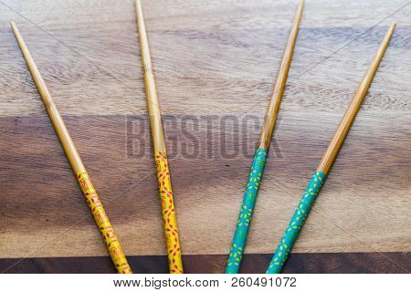 Natural Bamboo Chopsticks On Wooden Table Background.