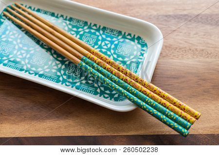 Natural Bamboo Chopsticks And Plate On Wooden Table Background.