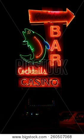 KALISPELL, MONTANA, USA - September 26, 2018: Rainbow Bar and Casino's neon sign lit up at night