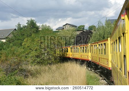 Latour De Carol - September 4, 2018: The Small Yellow Train Of The Pyrenees Crossing A Beautiful Mou