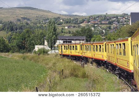 Latour De Carol - September 4, 2018: The Small Yellow Train Of The Pyrenees Crossing A Beautiful Mou