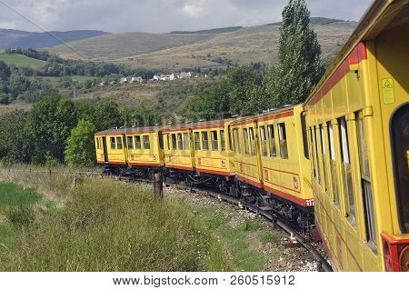Latour De Carol - September 4, 2018: The Small Yellow Train Of The Pyrenees Crossing A Beautiful Mou