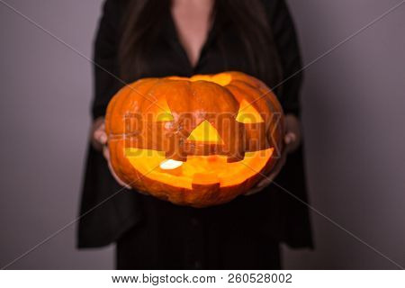 Jack O Lantern Halloween Pumpkin Grinning In The Most Evil Fashion In Woman's Hands Close Up