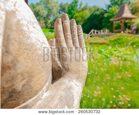 The Hands Of The Statue Are Laid With Palms For Meditation Against The Background Of The Asian Lands