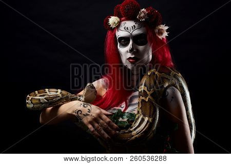 Monster Woman With Drawing Face With Black And White Make Up, And Flowers On Head, Posing With Long 