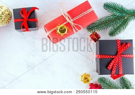 Christmas Decorative Background With Fir Branches, Cones, Redr And Black Christmas  Gifts, Ball On T