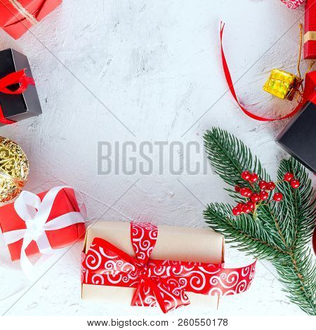 Christmas Decorative Background With Fir Branches, Cones, Redr And Black Christmas  Gifts, Ball On T