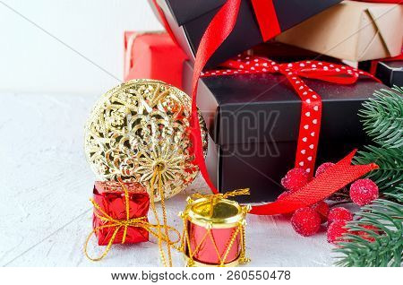 Christmas Decorative Background With Fir Branches, Cones, Redr And Black Christmas  Gifts, Ball On T