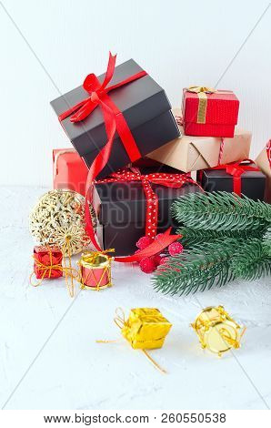 Christmas Decorative Background With Fir Branches, Cones, Redr And Black Christmas  Gifts, Ball On T