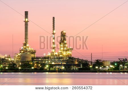 Oil Refinery River With Light In The Evening.