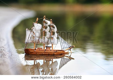 a toy sailing ship in the river