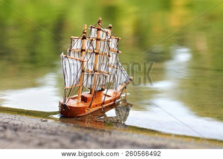 a toy sailing ship in the river