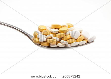 Spoon Full Of Tablets On White Fund