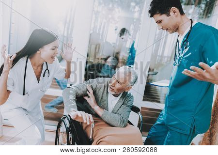 Elderly Very Frightened. Sitting In Wheelchair. Medical Workers. Argue With Elderly Couple. Nursing 