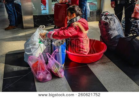 Yiwu/china - January 24 2015: Chinese People Wait For The Rocket Train To Go To Another City In Yiwu