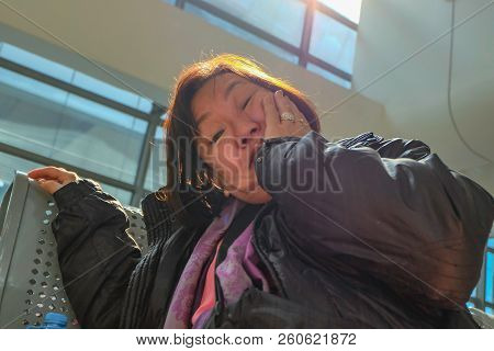 Old Asian Women Traveler Waiting For Transit To Shang Hai In Yiwu High Speed Train Terminal