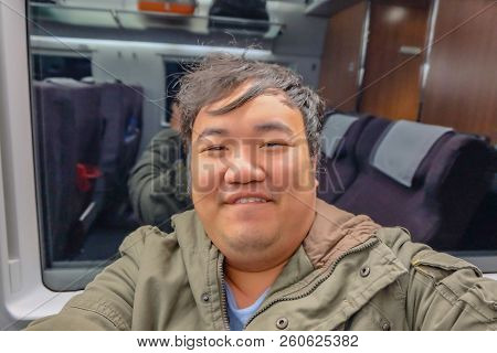 Asian Fat Traveler Selfie Himself On The High Speed Train From Yiwu City To Shanghai City In China