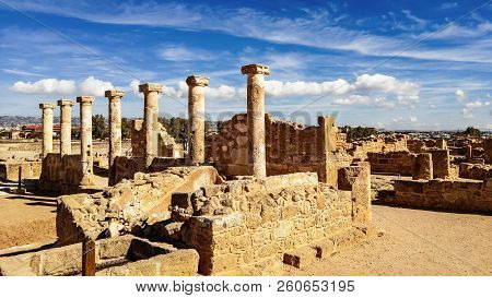 Ancient Ruins Of Kourion City Near Pathos And Limassol, Cyprus. Row Of Columns Under Blue Sky. Trave