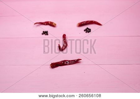 In Selective Focus Of The Horizental Dried Chili,on Pink Pastel Timber Board,blurry Light Design Bac