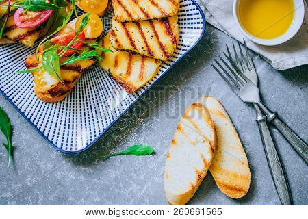 Bruschetta With Cherry Tomato Salad With Grilled Haloumi Cheese, With Chard And Arugula, Top View