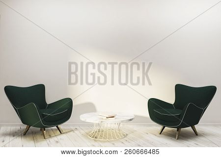 Interior Of Minimalistic Living Room With White Walls, Wooden Floor With Dark Green Armchairs And Co