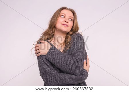 Close Up Portrait Of Caucasian Tender Woman With Curly Hair Wearing Gray Cardigan On White Backgroun
