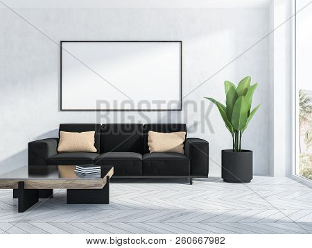 Interior Of Living Room With White Walls, White Wooden Floor With Black Couch And A Neat Coffee Tabl