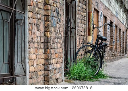 At The Old Brick Building Gutters With A Lock Connected The Black Bike.