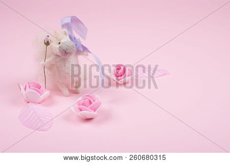 Tiny Unicorn Toy Made Of Wool, Handmade Rose Buds And Pink Leaves On A Pastel Pink Background (copy 
