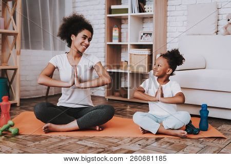 Mother With Young Girl Training. Smile Girl And Young Mother Sport For All Family. Yoga For Family. 