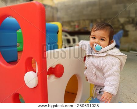 Baby Boy Playing With Plastick House Slide For Toddlers