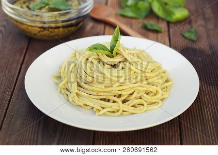 Italian Traditional Spaghetti With Basil Pesto Pasta With Cheese, Pine Nuts, Olive Oil, Rustic Table